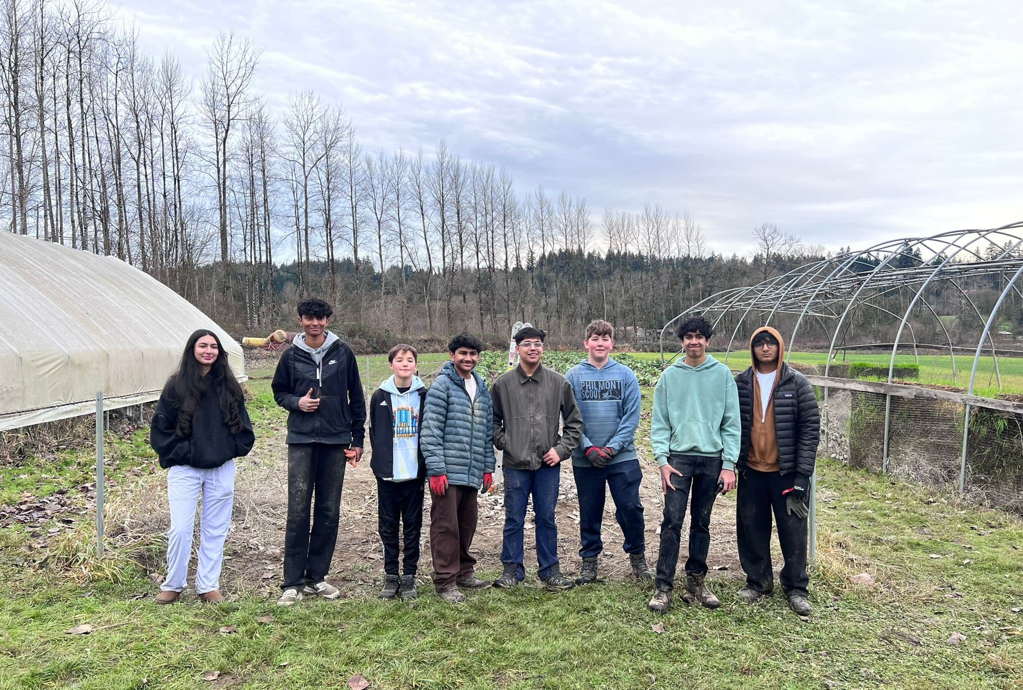 Project Refill volunteers posing in front of the restored Chinook Farms greenhouse, January 2026