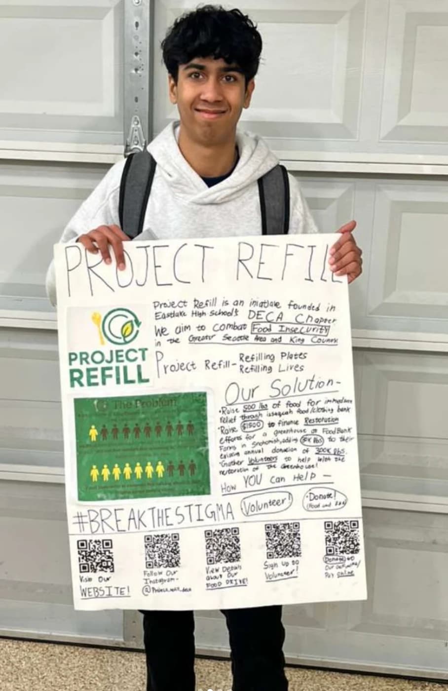 Founder holding the Project Refill poster during the fundraiser