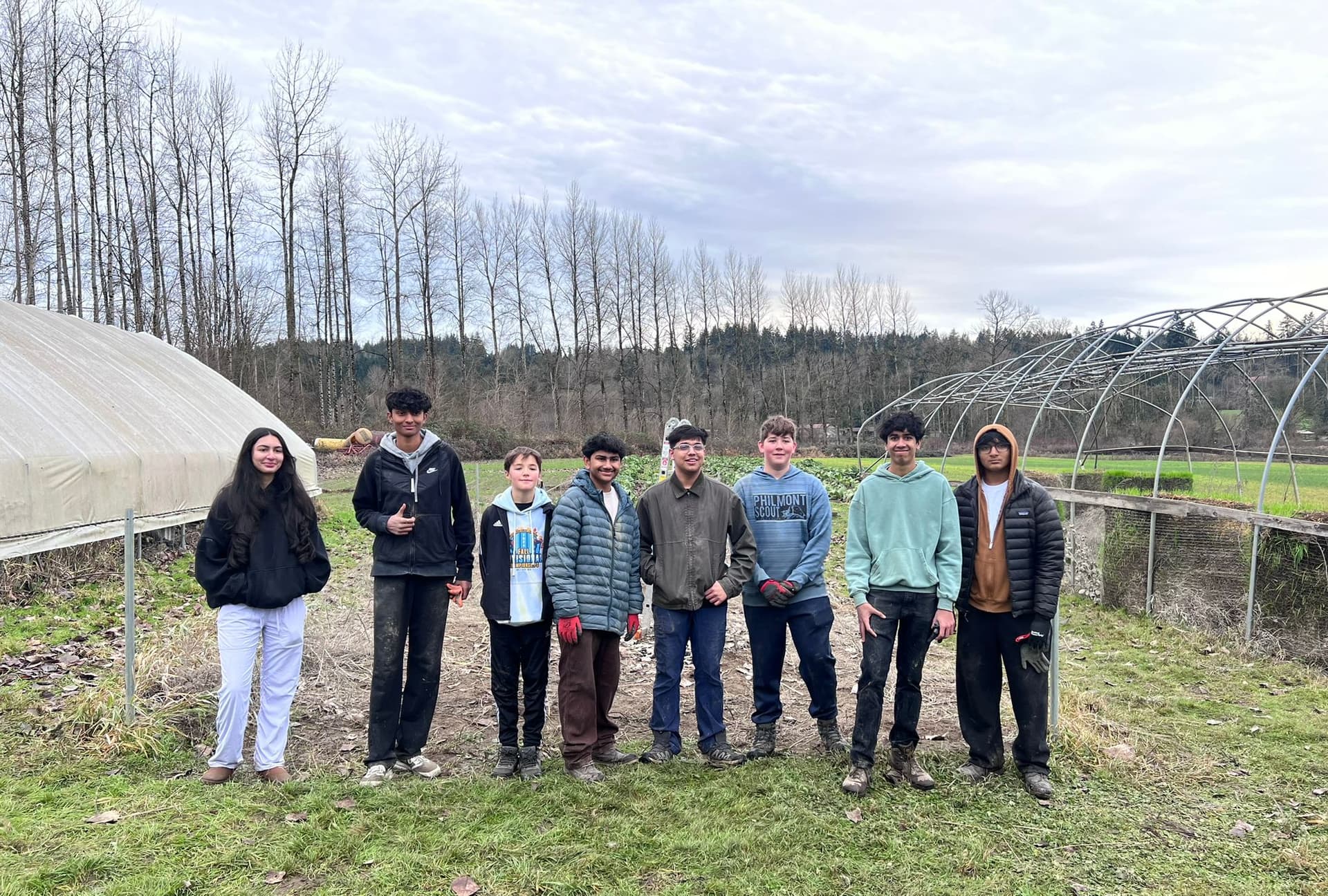 Project Refill volunteers posing in front of the restored Chinook Farms greenhouse, January 2026