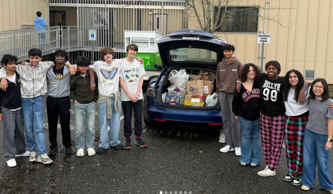 Student volunteers loading food into a car at Renaissance Middle School
