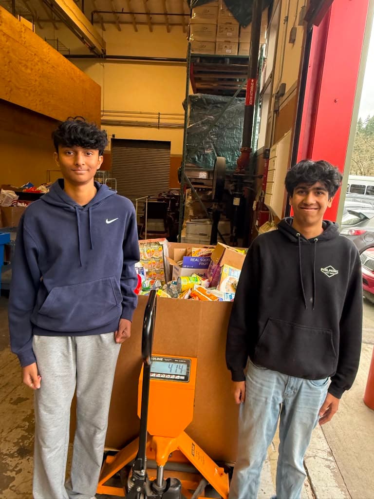 Founders with 414 lbs of donated food on the scale